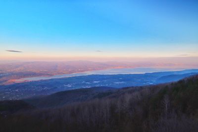 Scenic view of landscape against sky at sunset