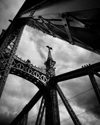 Low angle view of eiffel tower against cloudy sky