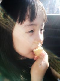 Close-up portrait of cute boy eating ice cream