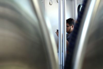 Close-up of man standing in bathroom