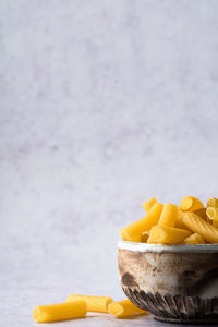 Close-up of yellow fruits in bowl on table