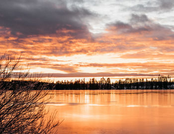 Scenic view of lake against orange sky