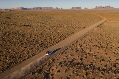 Tacoma truck long desert road toward iconic monument valley arizona