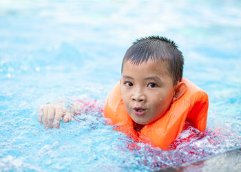 Portrait of boy swimming in pool