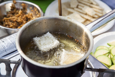 High angle view of food frying in container