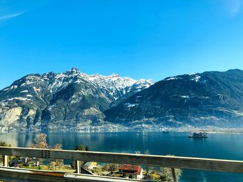 Scenic view of snowcapped mountains against clear blue sky