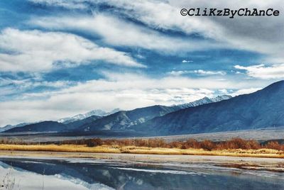 Scenic view of mountains against cloudy sky