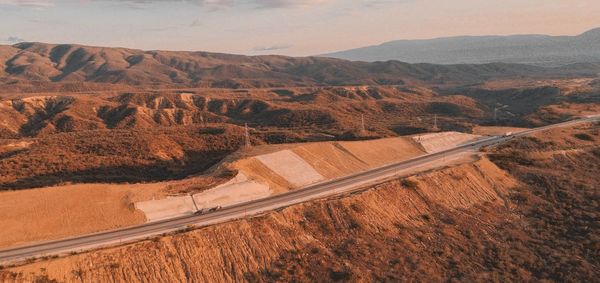 High angle view of road by mountains against sky