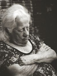 Woman looking at camera while sitting outdoors