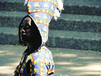 Man wearing traditional clothing while looking away outdoors