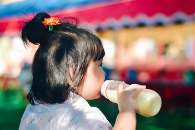 Side view of woman drinking water