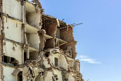 Low angle view of old building against clear blue sky