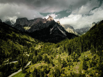 Open valley with a high mountains on the background. the peeks of the mountains are covered by cloud