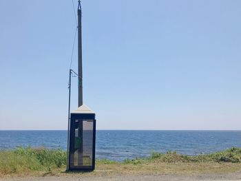 Lifeguard hut on beach against clear sky