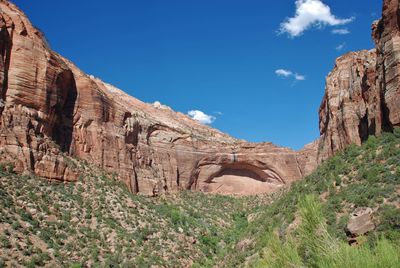 Low angle view of rock formation against clear blue sky