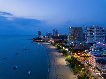 High angle view of city by sea against sky