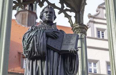 Low angle view of statue against building