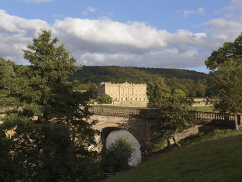 Arch bridge against cloudy sky