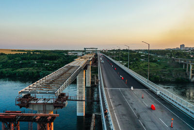 High angle view of bridge over city against sky during sunset