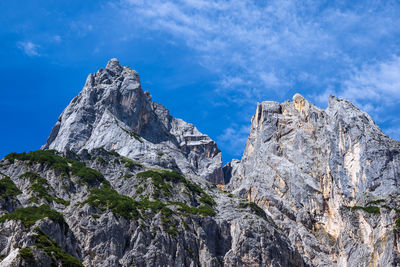 Low angle view of rocky mountains against sky