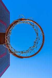 Low angle view of basketball hoop against blue sky