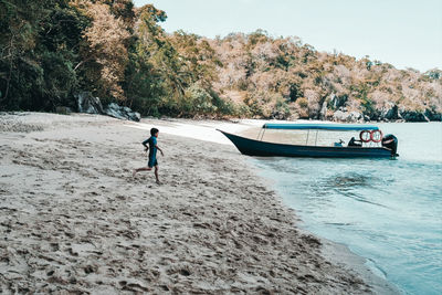 Man on beach against sky