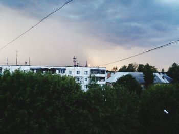 Trees and buildings against sky