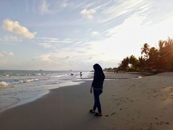 Full length of woman on beach against sky