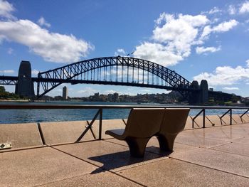 Arch bridge over river against sky