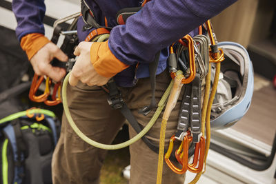 Rock climber putting gear on