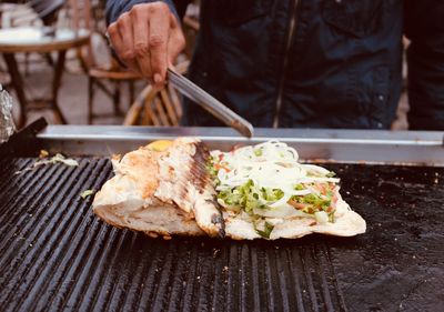 Close-up of hand holding food on table