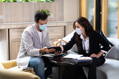 Businessman and female colleague planning at home