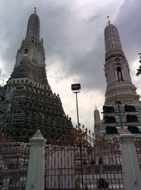 Low angle view of monument against cloudy sky