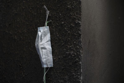 Close-up of clothes drying on clothesline against wall