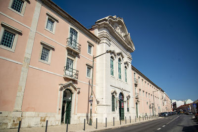 Low angle view of buildings against clear blue sky