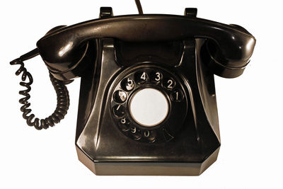 Close-up of old telephone against white background