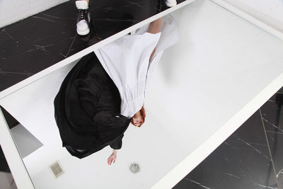 High angle view of woman reflecting in mirror