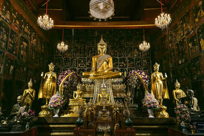 Low angle view of statue against illuminated building