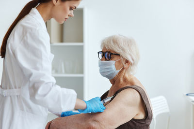 Midsection of woman wearing mask