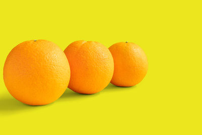 Close-up of oranges against orange background