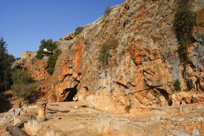 Rock formation on mountain against clear sky