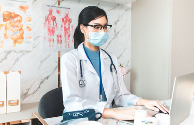 Midsection of man using mobile phone