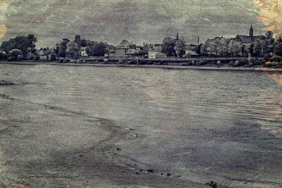 View of calm sea against buildings