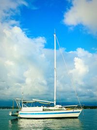 Ship sailing in sea against sky