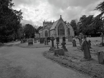 View of cemetery and buildings against sky