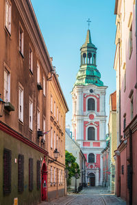 Street amidst buildings against sky in city