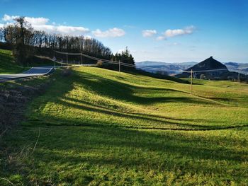 Scenic view of agricultural field against sky