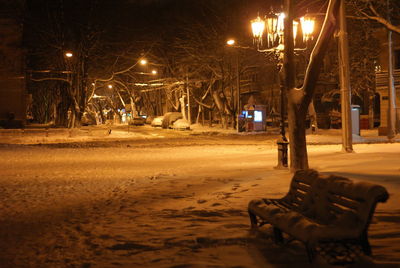 Street light on snow covered city at night