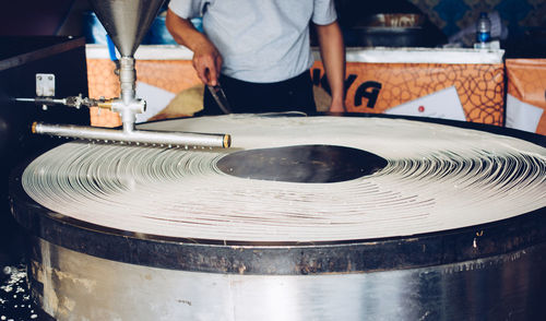 Midsection of man preparing food