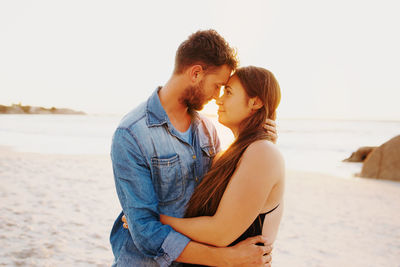 Young couple standing on beach